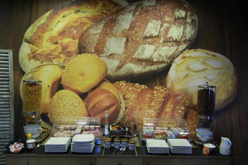 a bunch of different types of bread on a table at Logis- Hôtel de la Baie de Wissant & Appartements in Wissant