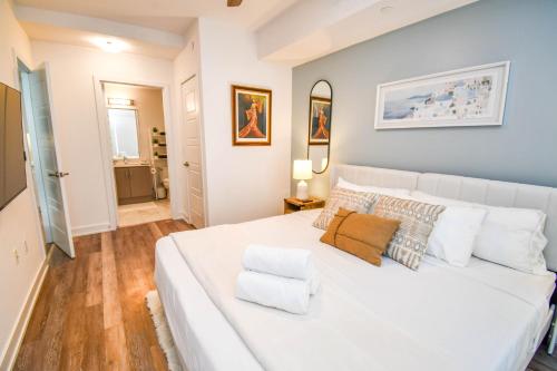 a bedroom with a large white bed with white pillows at Golf Paradise Pool Fire Pit King Bed in Innisfil