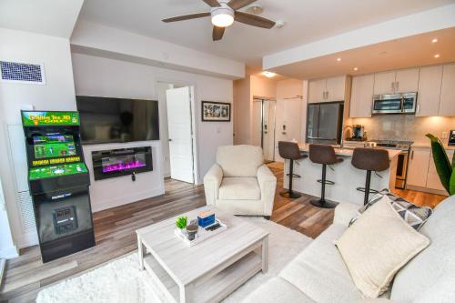 a living room with a couch and a video game at Golf Paradise Pool Fire Pit King Bed in Innisfil