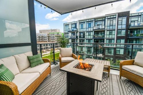 a balcony with two couches and a fire pit at Golf Paradise Pool Fire Pit King Bed in Innisfil