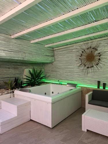 a jacuzzi tub in a room with green lighting at VENTINOVE Apartments in Otranto