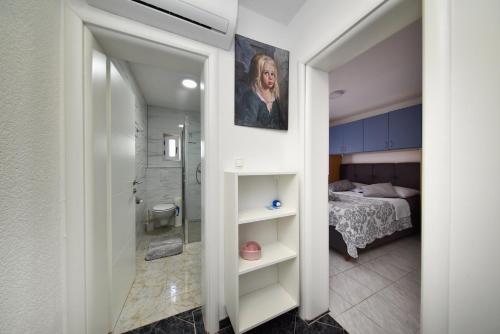 a hallway leading to a bedroom with a bed at Kaurinovic in Zaton