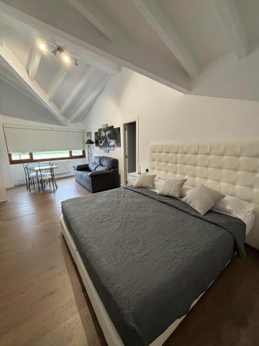 a large bedroom with a large bed and a couch at La Casa Del Buddha - Adults Only in Suances