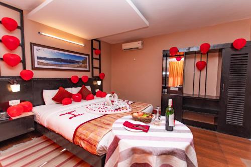 a bedroom with a bed with red hearts on the wall at Moonlight Resort and Spa in Pokhara