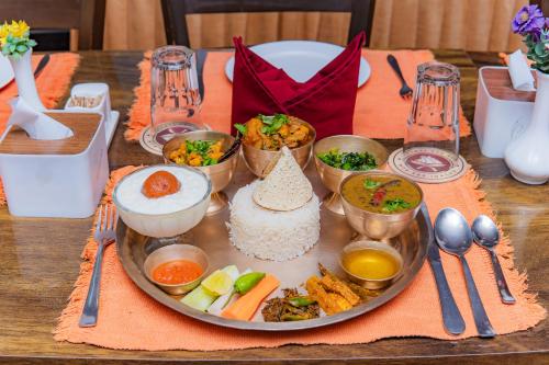 a tray with rice and other food on a table at Moonlight Resort and Spa in Pokhara