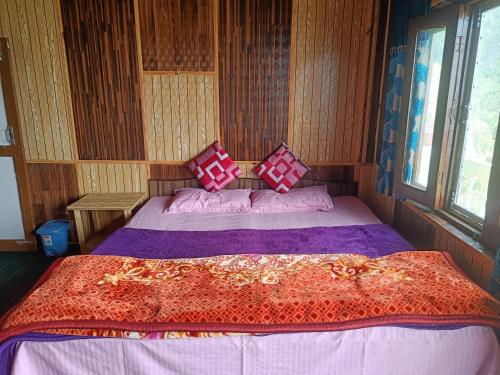 a bedroom with a large bed in a room at Jet Home Stay in Theog