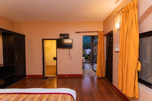 a bedroom with a bed and a tv in a room at Moonlight Resort and Spa in Pokhara