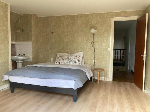 a bedroom with a bed with pillows on it at 5 Chambres dans une grande maison in Auneau