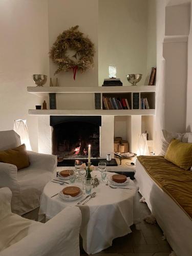 a living room with a table and a fireplace at Dar El Qadi in Marrakech