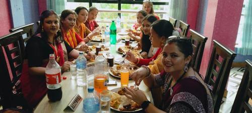 a group of people sitting at a table eating food at Hotel Royal Inn Nuwakot in Trisūli Bāzār