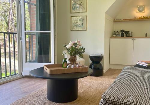 a living room with a table with flowers on it at Villa Brigitte in Le Touquet-Paris-Plage