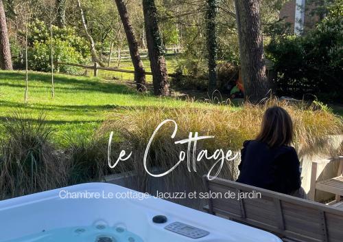 a woman sitting on a bench next to a bath tub at Villa Brigitte in Le Touquet-Paris-Plage