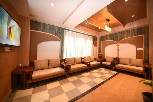 a waiting room with couches and a checkered floor at Hotel Vistara in Kathmandu