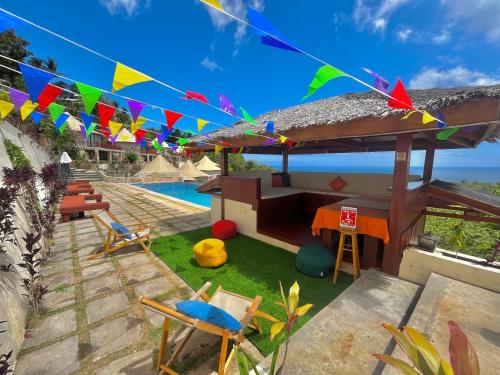 a house with a yard with chairs and flags at InSense Mountainview Resort in Siquijor