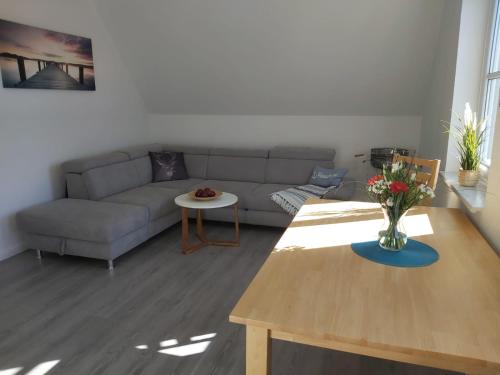 a living room with a couch and a table at Wohnung Sonnenschein Wolgast in Wolgast