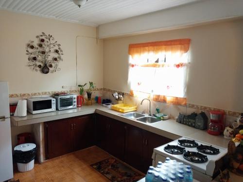 a kitchen with a sink and a stove top oven at D Quiet Spot Vacation Rental in Peñal