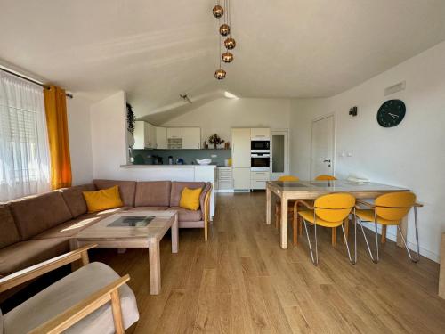 a living room with a couch and a table and chairs at Three Bedroom Luxury Apartment Jasmin in Bar