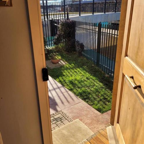 an open door with a view of a yard at Casa magallanica in Punta Arenas