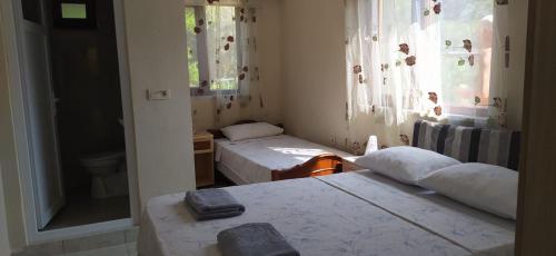 a small room with two beds and a window at Çirali Sunny House in Kemer