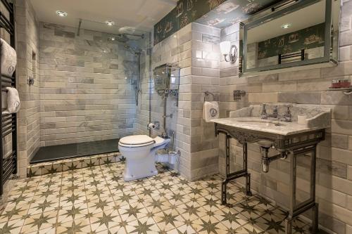a bathroom with a toilet and a sink at Georgian House Hotel in Whitehaven