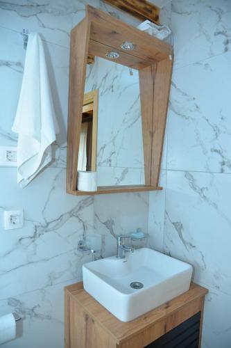 a bathroom with a sink and a mirror at Zagrad Homes in Zabljak in Žabljak