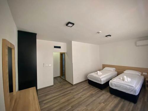 a hotel room with two beds and a mirror at Ragusa Villa in Stolac
