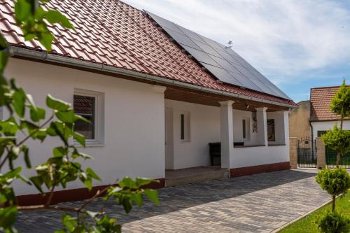 a house with solar panels on its roof at Kövirózsa Vendégház in Cserépfalu