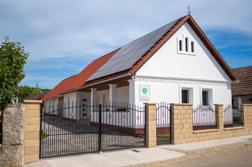 a house with solar panels on the roof at Kövirózsa Vendégház in Cserépfalu