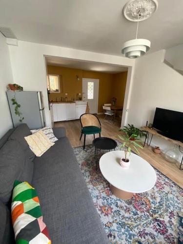 un salon avec un canapé et une table dans l'établissement Maison de village la digue, à Fabrègues