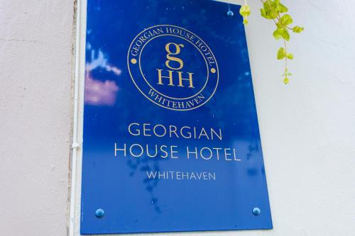 a sign for a german house hotel on a wall at Georgian House Hotel in Whitehaven