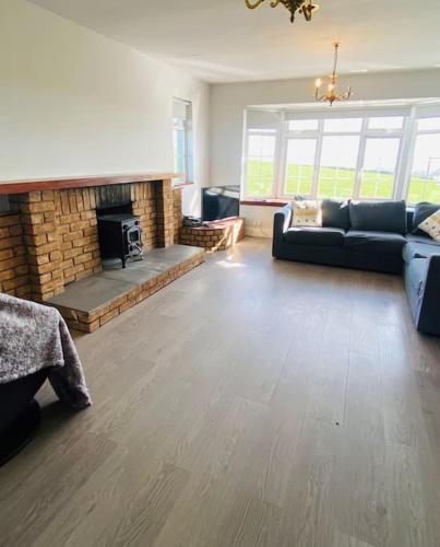 a living room with a couch and a fireplace at Valley Lodge 3 BR Retreat in Craigantlet Hills in Belfast