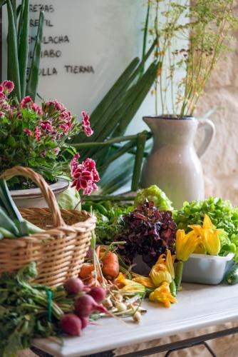 a table with a bunch of vegetables and a basket at La Torre del Visco - Relais & Châteaux in Fuentespalda