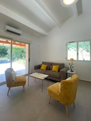 a living room with a couch and two chairs at Mas des Anges in Sauve