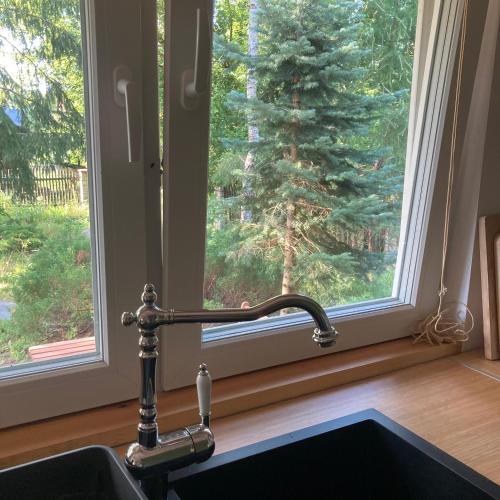 a window with a faucet next to a sink at Letnia Oficyna in Okoniny Polskie