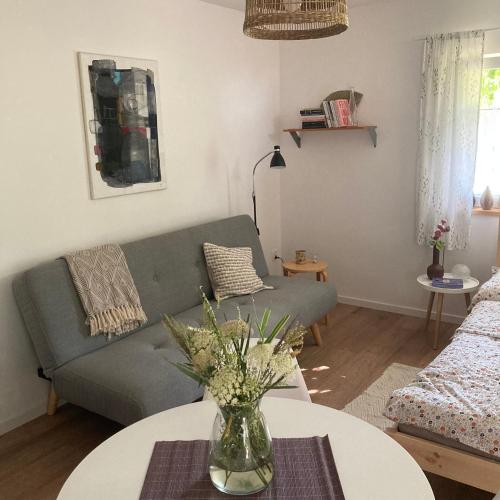 a living room with a couch and a table at Letnia Oficyna in Okoniny Polskie