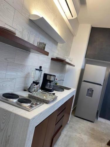 a kitchen with a blender on top of a counter at MID-498 Centro in Mérida
