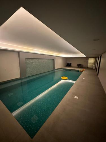 a swimming pool with a yellow frisbee in it at Pinnacle Row Comfort Corner in Muscat