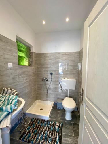 a bathroom with a toilet and a sink and a shower at Batis Breeze Studio in Corfu