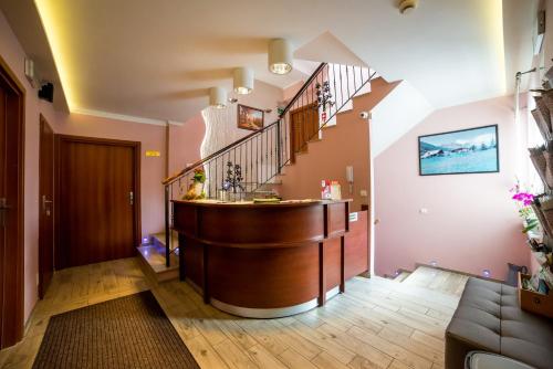 a living room with a staircase and a sink at Pensjonat PANORAMA in Karpacz