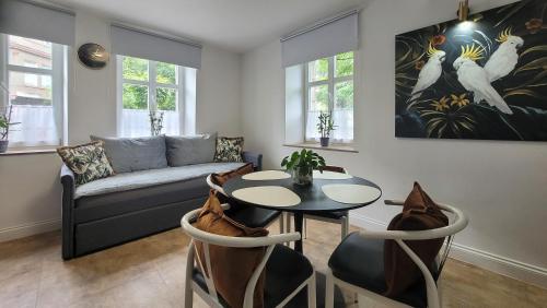 a living room with a table and a couch at Apartamenty Pocztowe in Opolno Zdrój