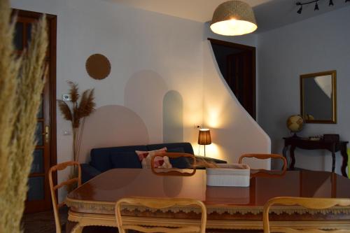 a living room with a table and a couch at Vista Mare in Mattinata