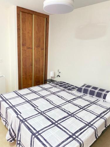 a bedroom with a large bed in a room at Apartamentos Peñaflor in Guadix