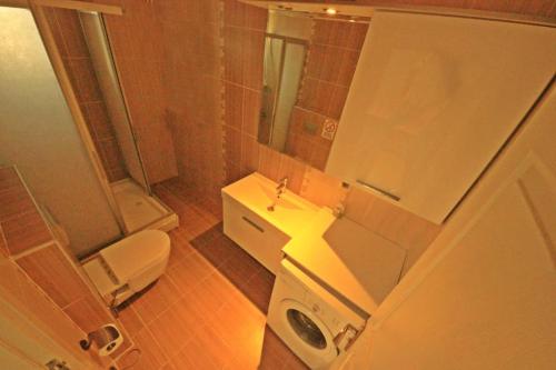 a bathroom with a toilet and a sink at Poseidon Marine Villa in Ildır