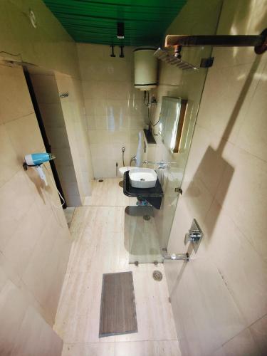 a view of a bathroom with a sink and a mirror at The Vacation Villa in Agra