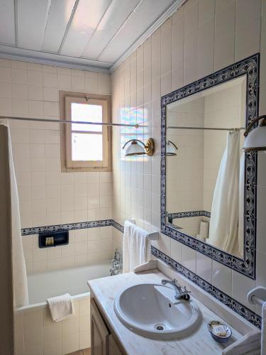 a bathroom with a sink and a mirror and a tub at Casa de São Cucufate - Casa de Campo in Vila de Frades