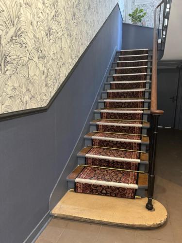 a set of stairs with a rug next to it at Le Florus in Montrouge