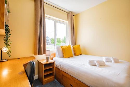 a bedroom with a large bed with a window at 56 - Three Bed Apartment With Parking in Galway