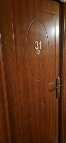 a wooden door with the number on it at Studio Nord in Bucharest