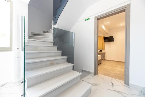 a staircase in a house with a glass door at Airscape Hotel Free Shuttle From And To Athen's Airport in Artemida