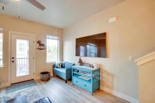 a living room with a blue couch and a tv at Lovely McCall Retreat Less Than 2 Mi to Payette Lake! in McCall